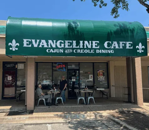 Evangeline Cafe storefront with green awning and outdoor seating in South Austin